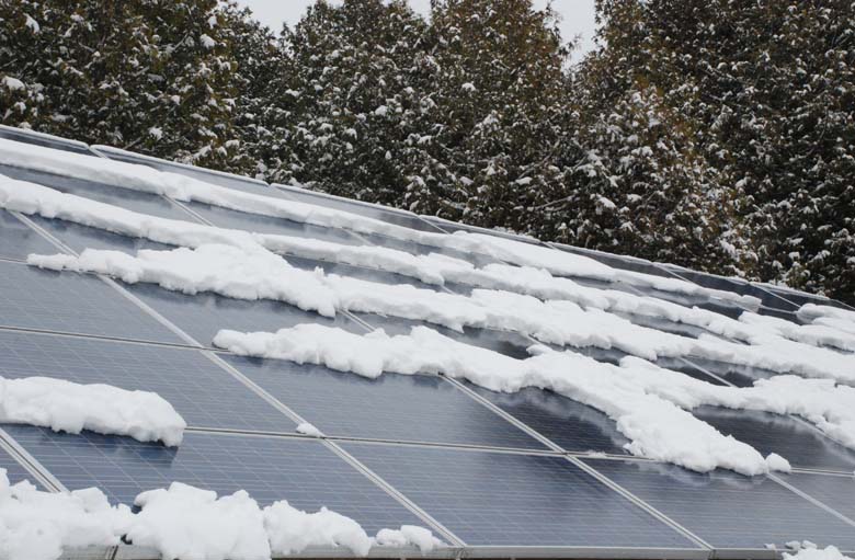 Solar panels with patches of snow melting tanken late March 2014